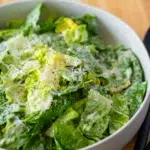 Close Up of Lettuce dressed with Caesar Salad Dressing