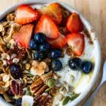 Overhead shot of homemade granola with mixed nuts and dried berries.
