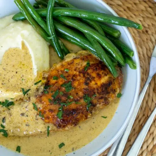 Creamy Garlic Chicken plated with mash potato and green beans