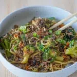 Hearty Beef and Broccoli Noodles presented with chopsticks for serving