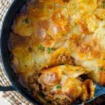 Full beef and potato pie in one pan, with a golden flaky crust.