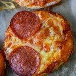Close-up of mini pizzas, highlighting the crispy dough, rich tomato sauce, and gooey mozzarella with pepperoni slices