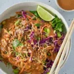 Cold Sesame Peanut Pasta Salad in a bowl and a pair of chopsticks on top.
