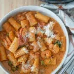 Overhead view of Creamy Cajun Prawn Pasta in a pan with a serving spoon.