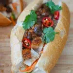 Close-up of Pork Belly Banh Mi showcasing the filling and sauce.