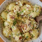 Ultimate loaded potato salad in a white bowl