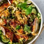 Overhead shot of Sesame-Soy Dumpling Salad featuring dumplings, mixed greens, and colorful veggies.