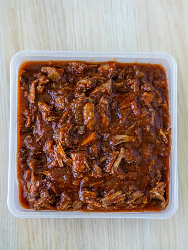 Flavorful beef ragu in a container, perfect for meal prep.