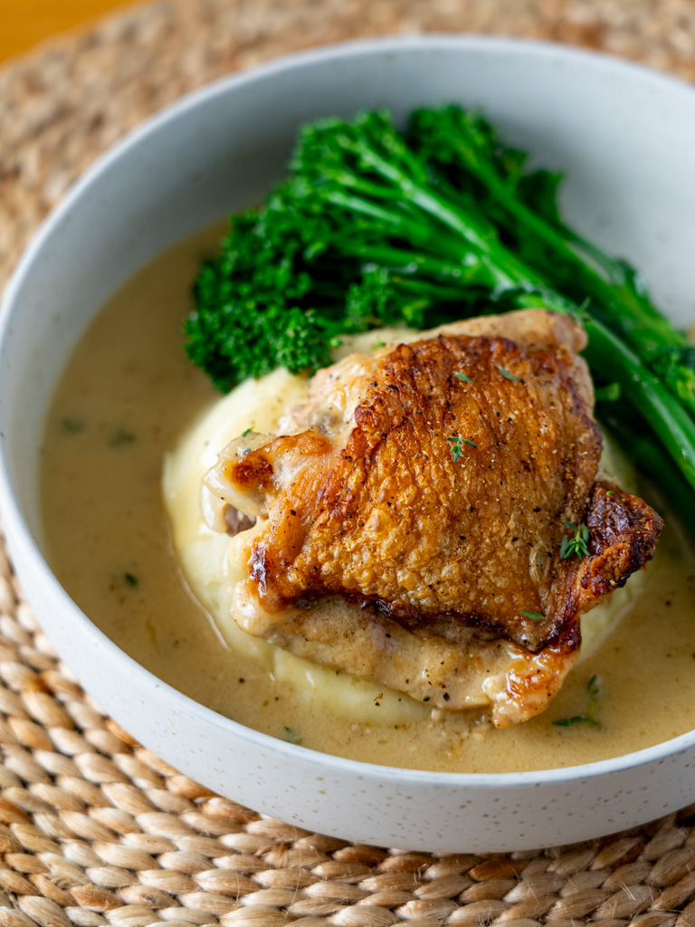 Side view of baked Dijon chicken plated and ready to serve.