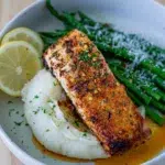 Side view of plated salmon with mashed potato and asparagus