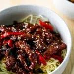 Side view of two servings of Sticky Rainbow Beef in bowls