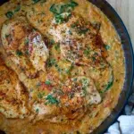 Top view of chicken with creamy red pesto risoni served in a pan.