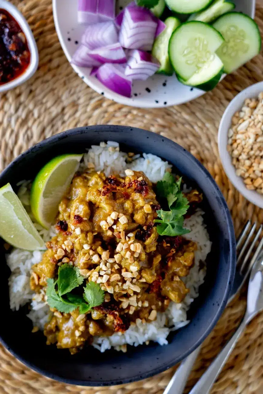Top view Speedy Satay Chicken Recipe with sliced cucumber and red onion sides