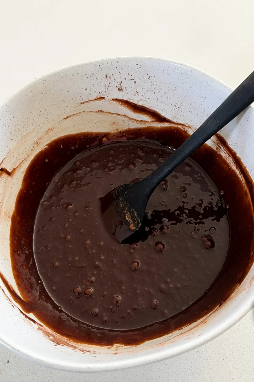 Wet and dry ingredients mixed together smooth shiny batter