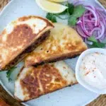 plated stuffed pita arayes with pickled onion coriander and dip