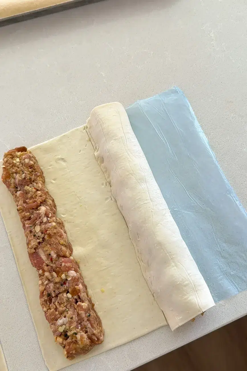 sausage roll mixture on puff pastry