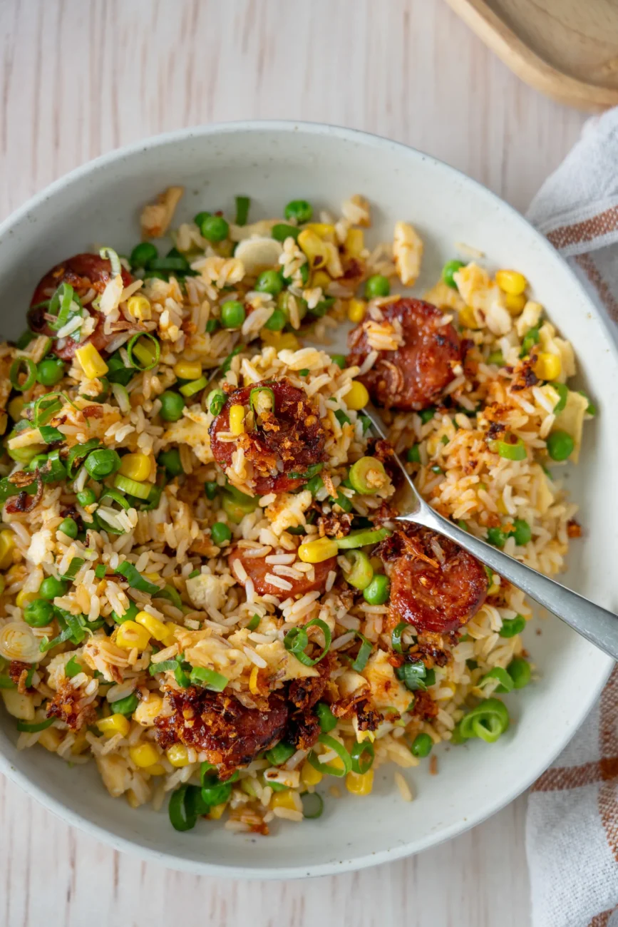 spoon in bowl of baked chorizo fried rice