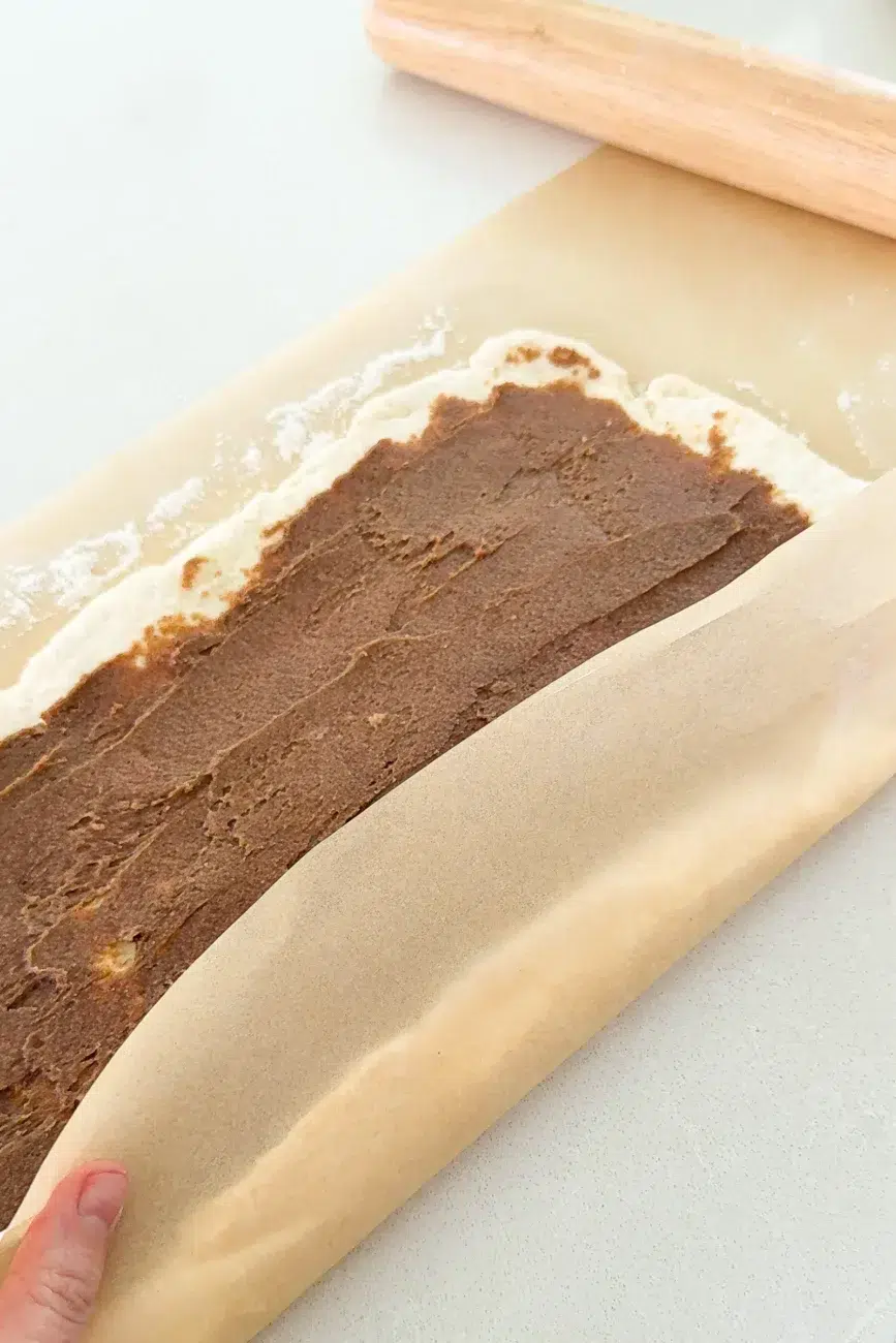 Easy no yeast cinnamon scrolls dough and filling being rolled