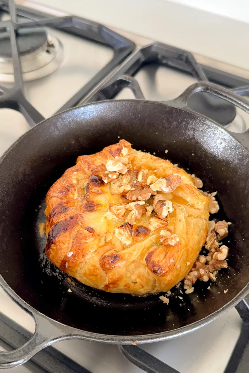 Baked Brie topped with nuts before final bake