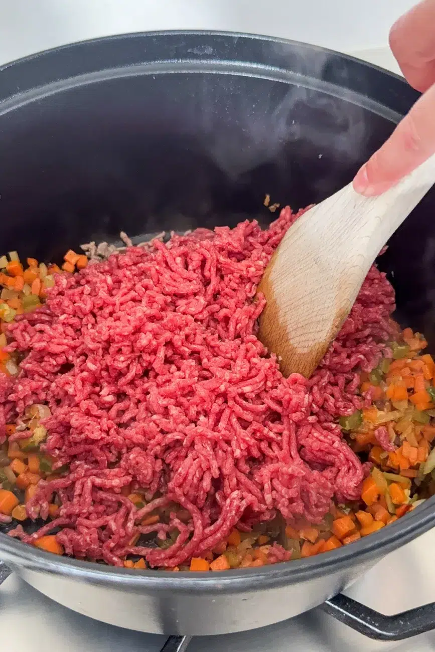 Beef minced added to softened veggies in pan