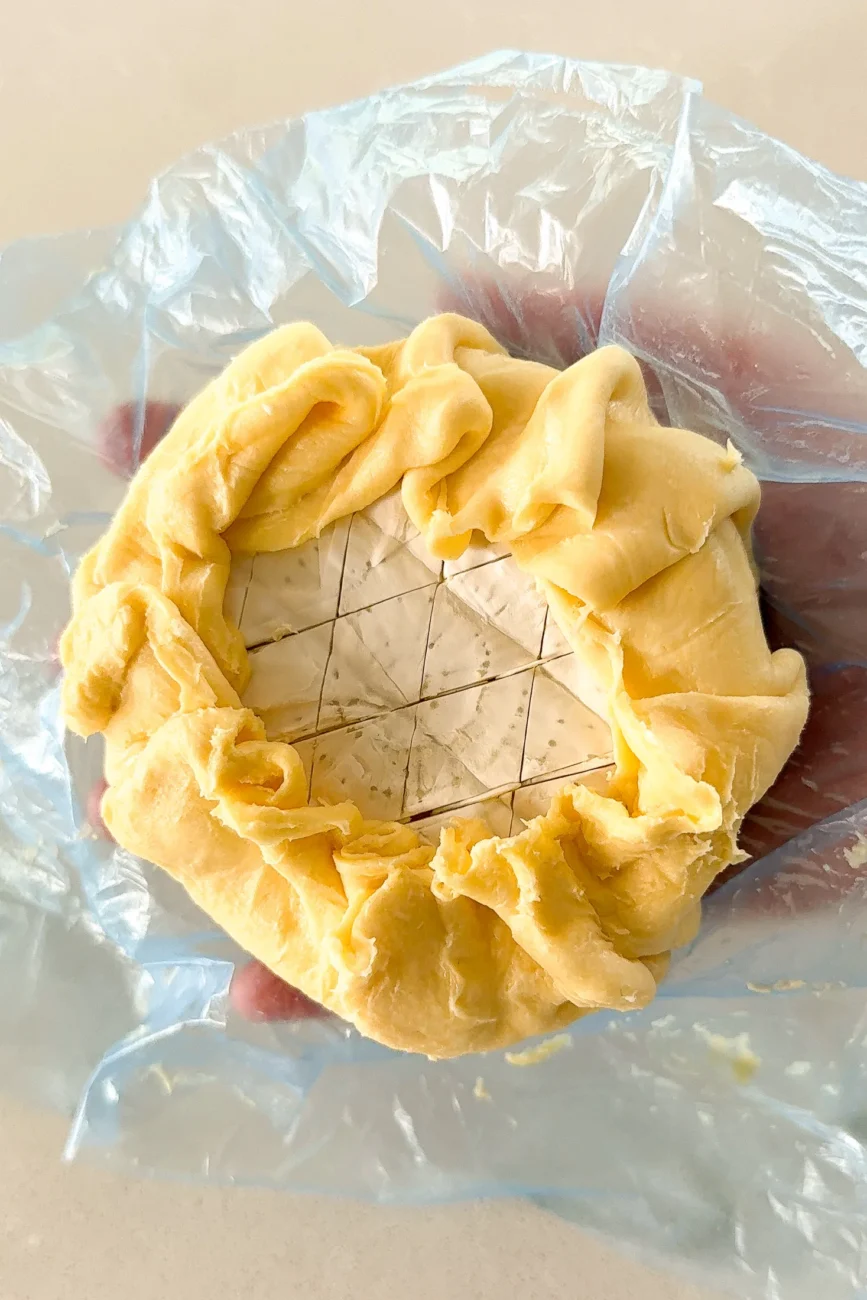 Brie encased with pastry before egg wash