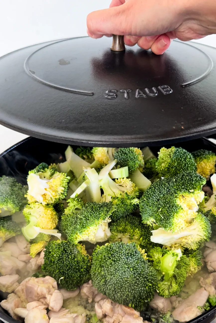 Broccoli added to chicken and aromatics