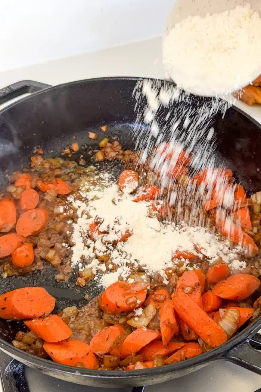 Flour being sprinkled into pan