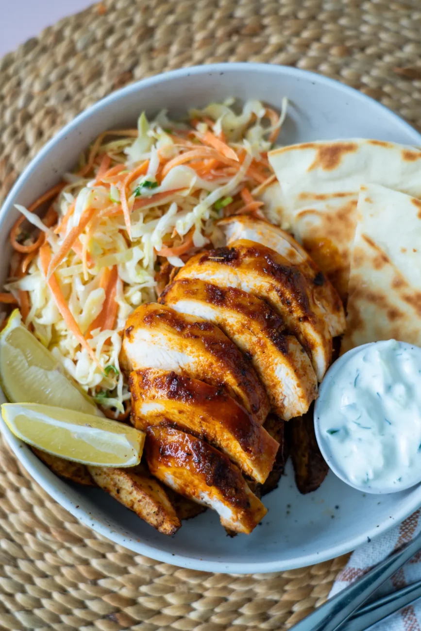 Sliced baked chicken breast rotisserie style with lemon