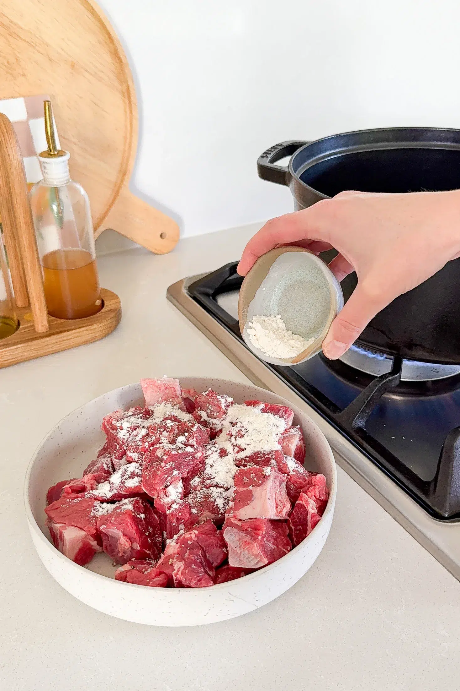 Beef chuck pieces seasoned with salt pepper and flour before browning