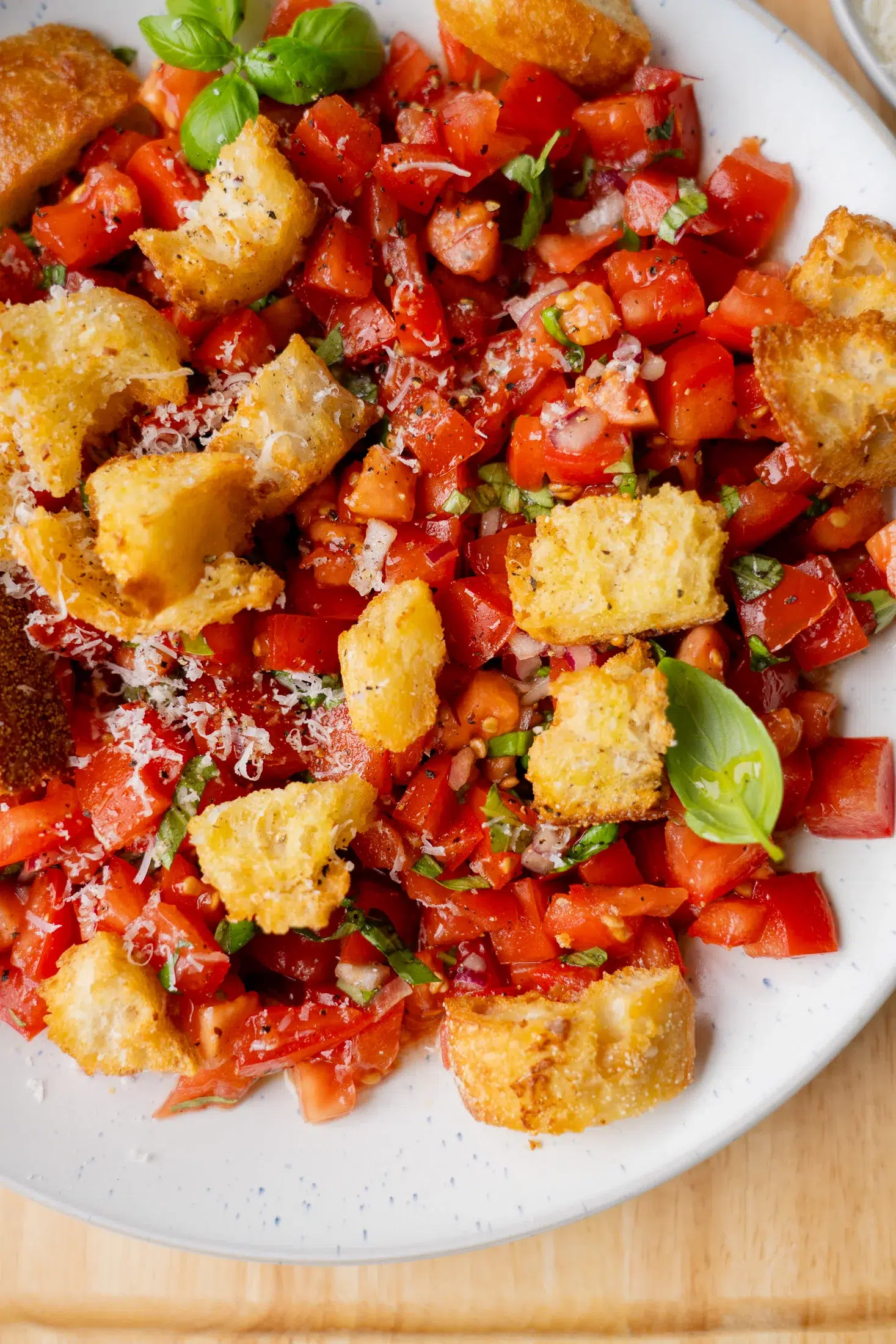 Top view of bruschetta tomato salad with fresh basil