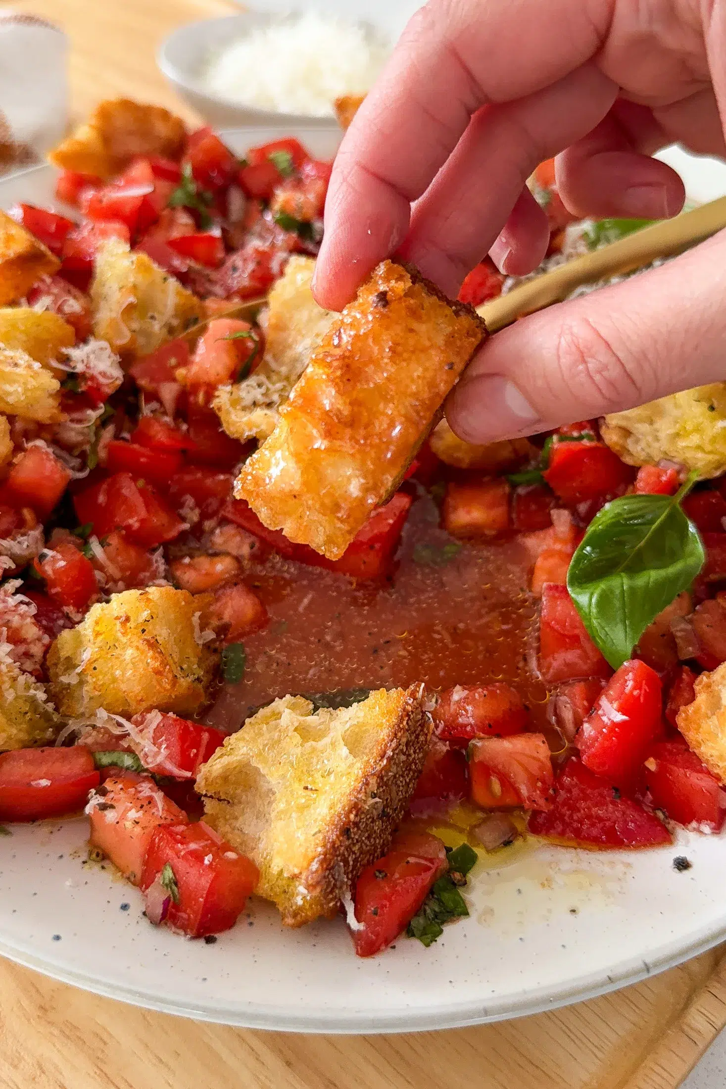 A garlic parmesan crouton dipped in bruschetta salad dressing