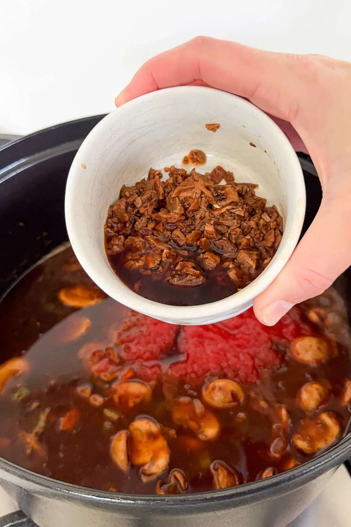 Hydrated porcini mushrooms and soaking liquid added to beef ragu
