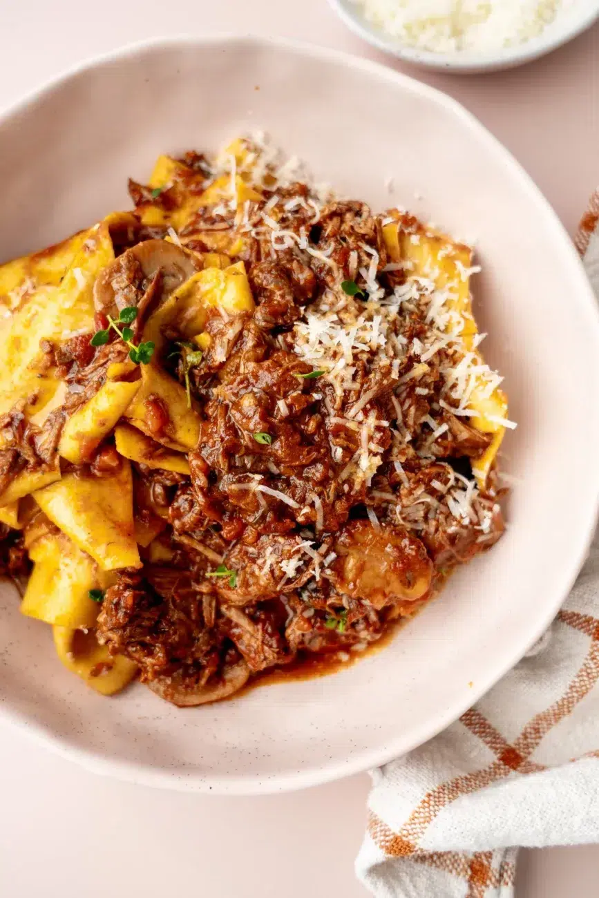 Slow-cooked beef and mushroom ragu served over fresh pappardelle with parmesan