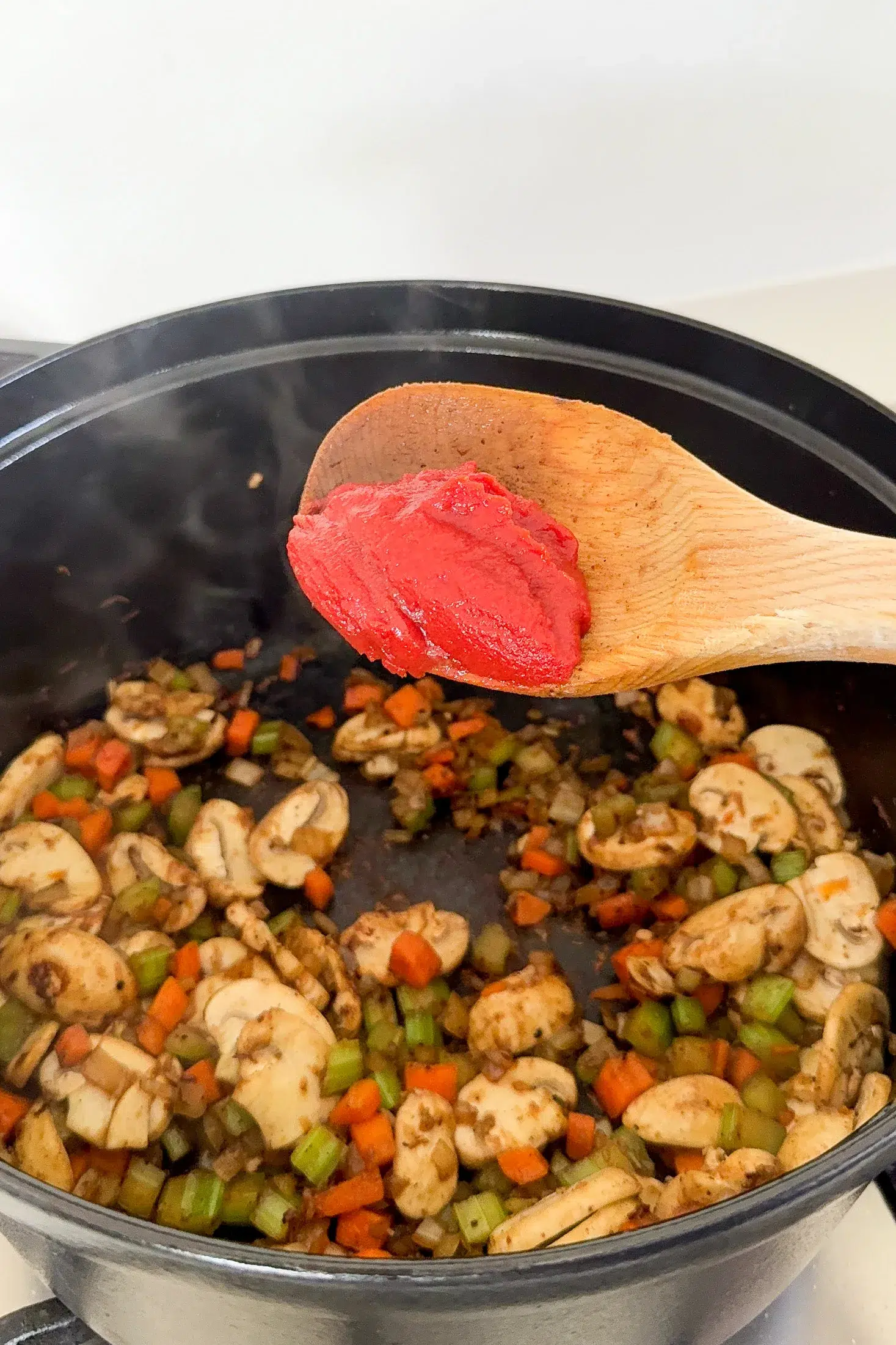 Softened vegetables and mushrooms with tomato paste for beef ragu