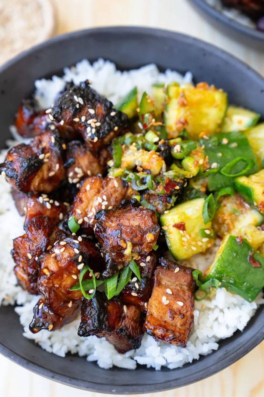 Pork belly bites with steamed rice and smashed cucumbers