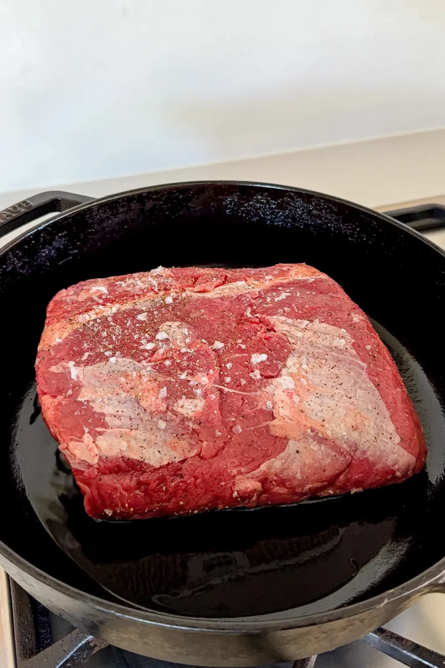 Raw chuck roast beef seasoned and ready to be seared