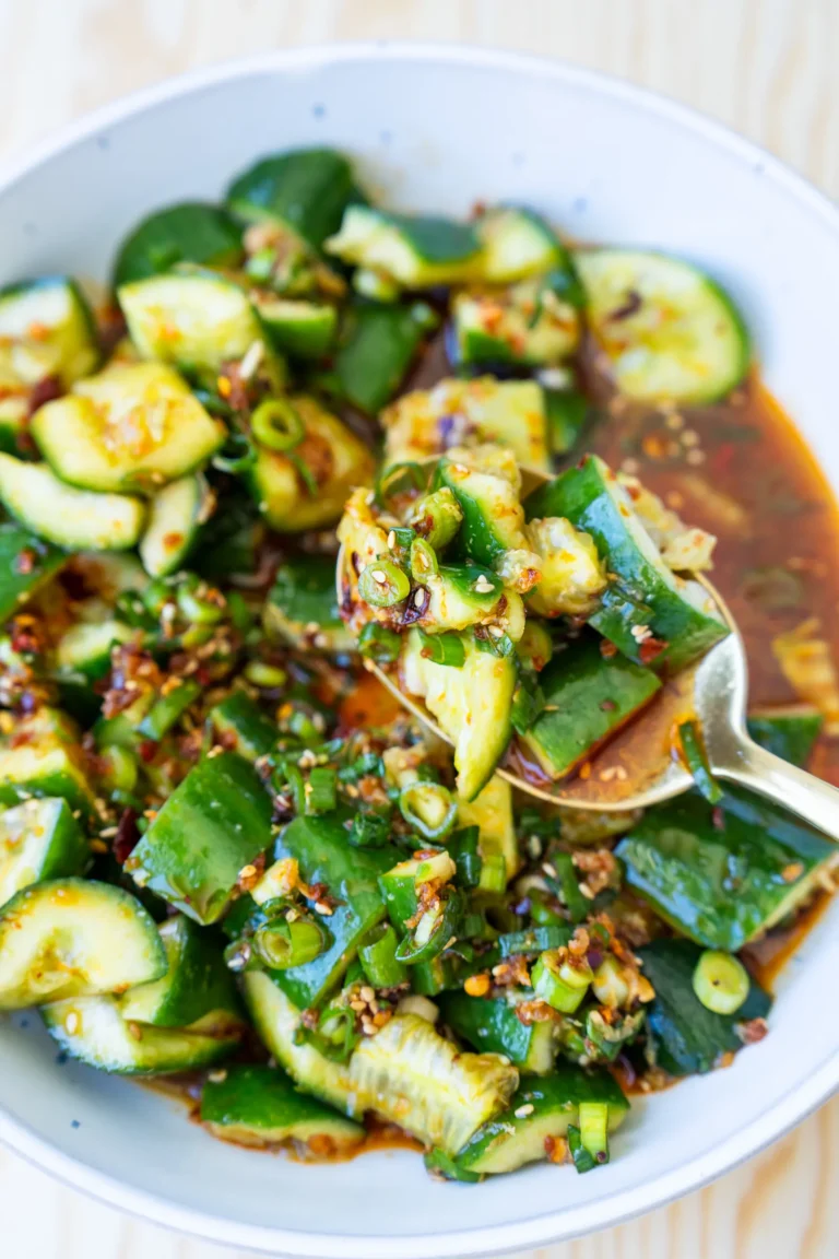 Smashed asian cucumber salad being scooped with spoon