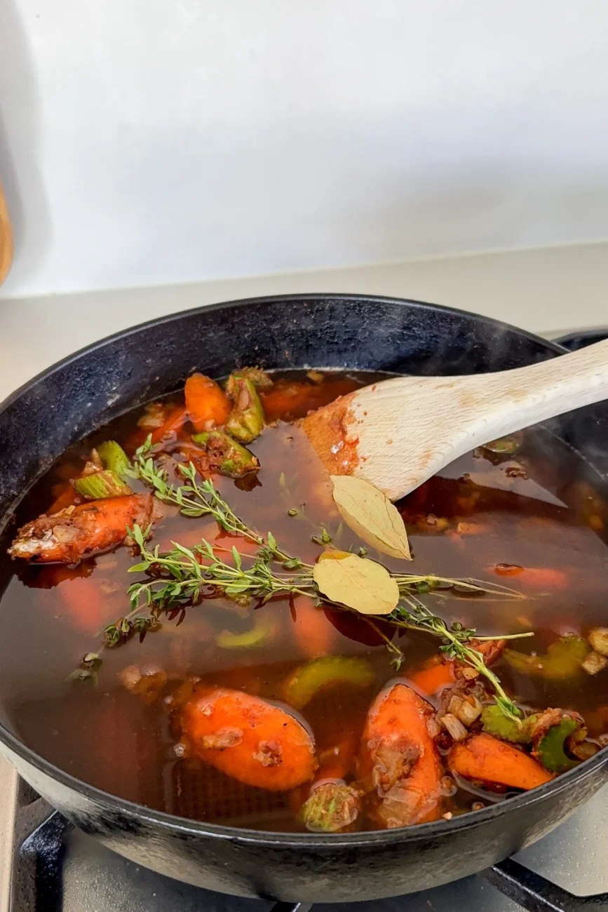 Stock herbs worcestershire sauce and stock added to pan