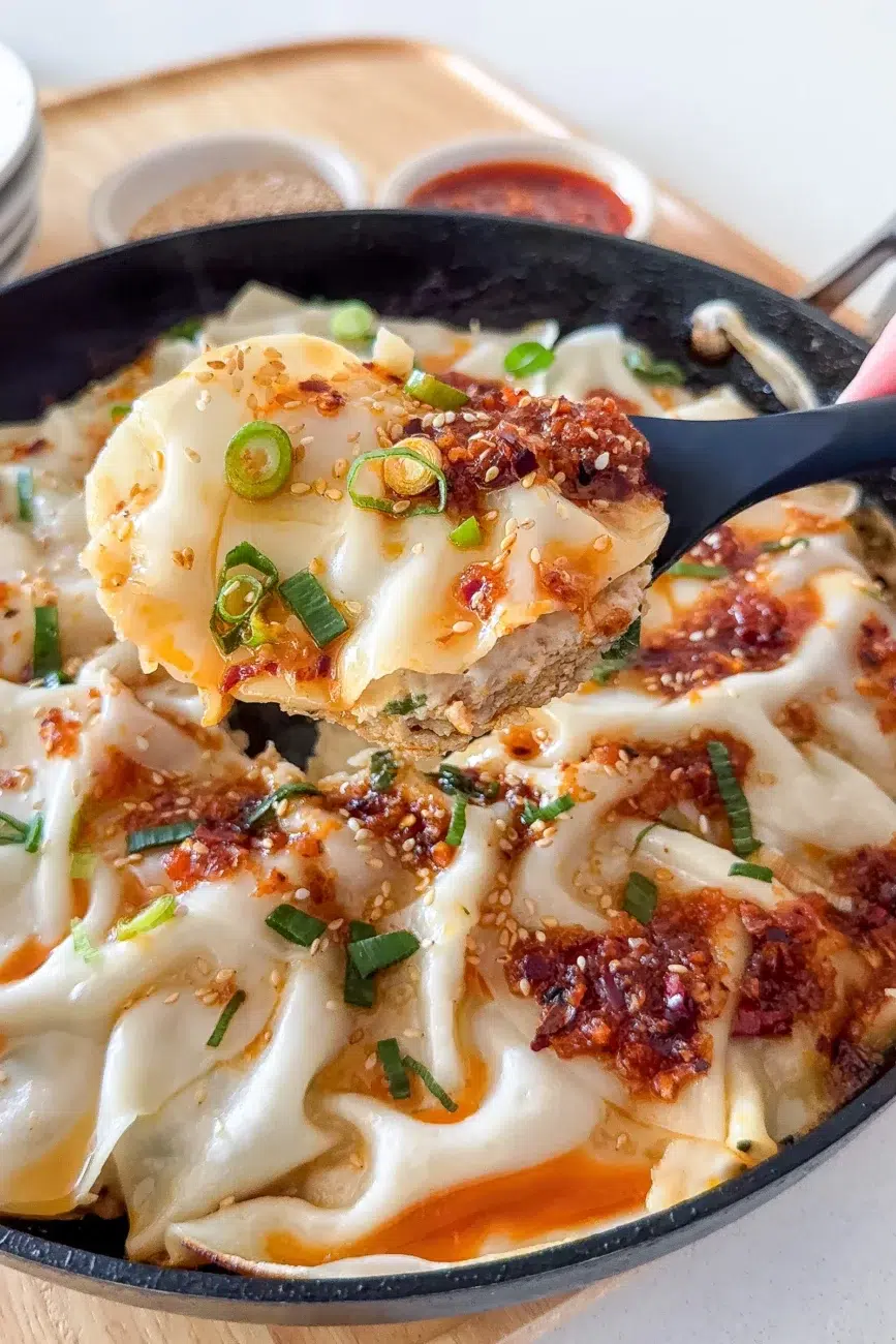 The dumpling lasagne being scooped from the pan