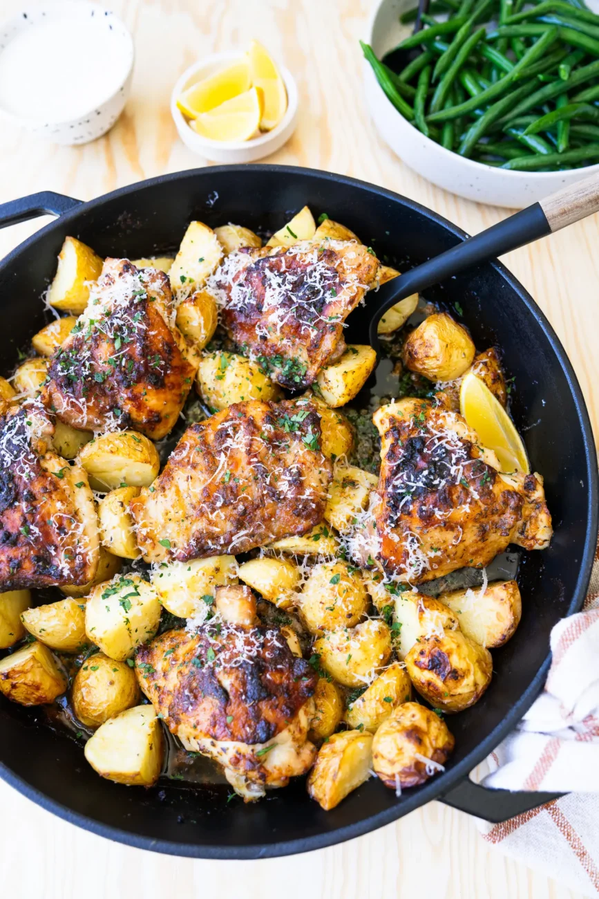 Chicken in baking dish with spatula ready to dig in