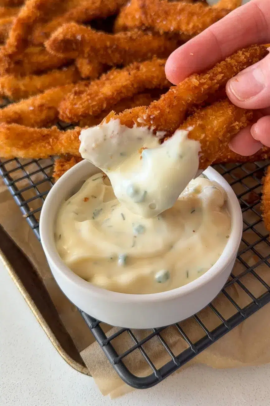crispy chicken finger dipped into ranch dressing