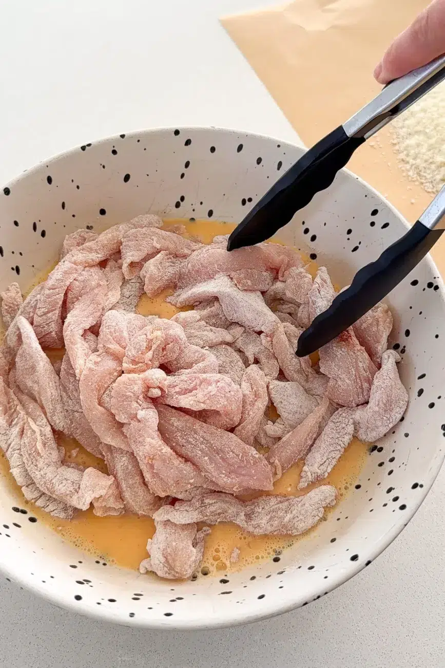 floured chicken fingers added to egg mixture