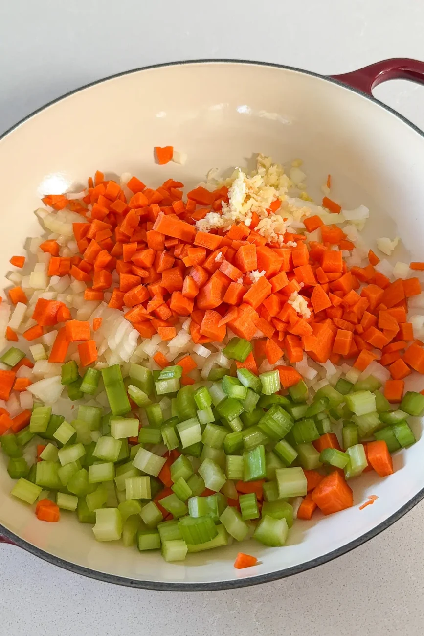 onion carrot celery and garlic in casserole dish