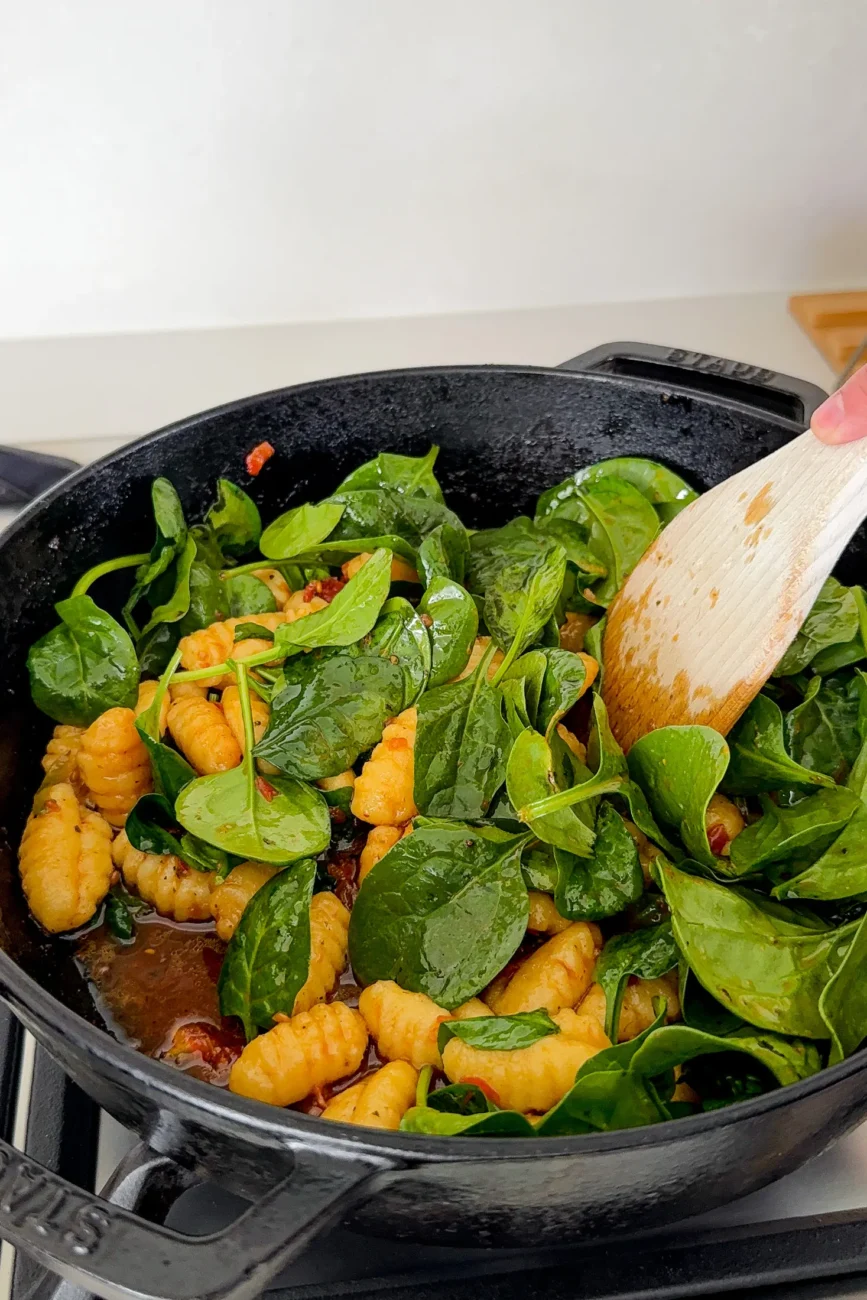 Adding the spinach to pan