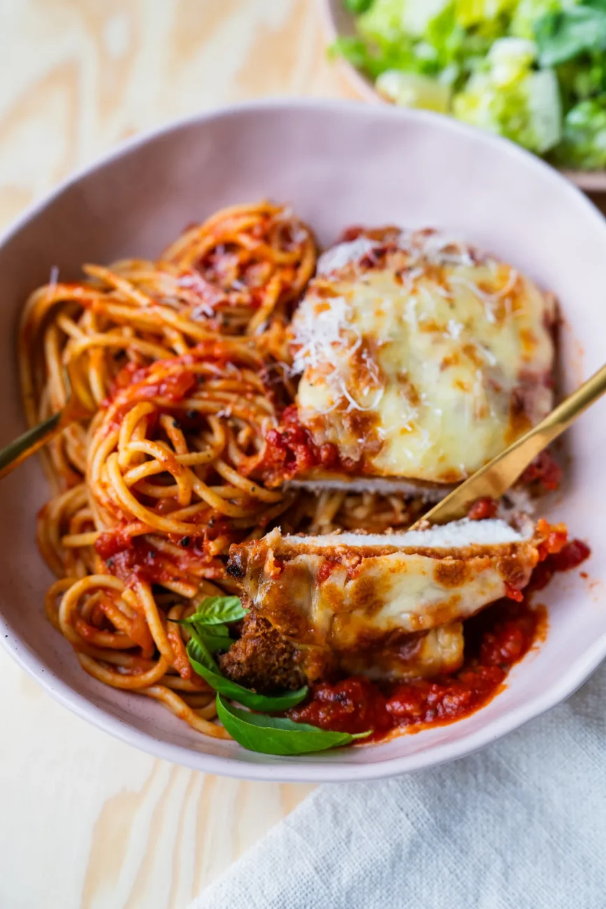 Chicken parmigiana cut to reveal tender and juicy chicken