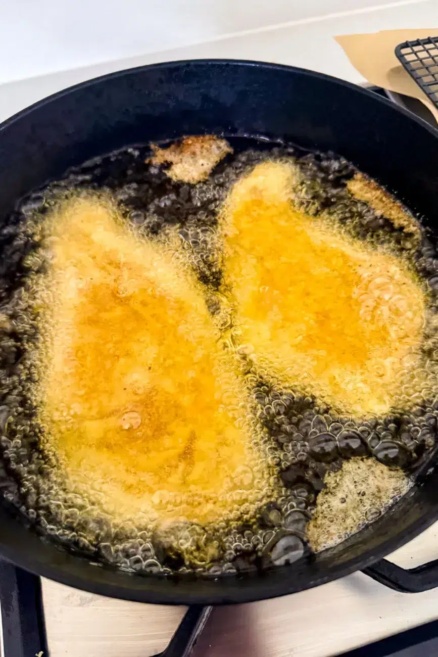 Chicken schnitzels shallow frying in olive oil