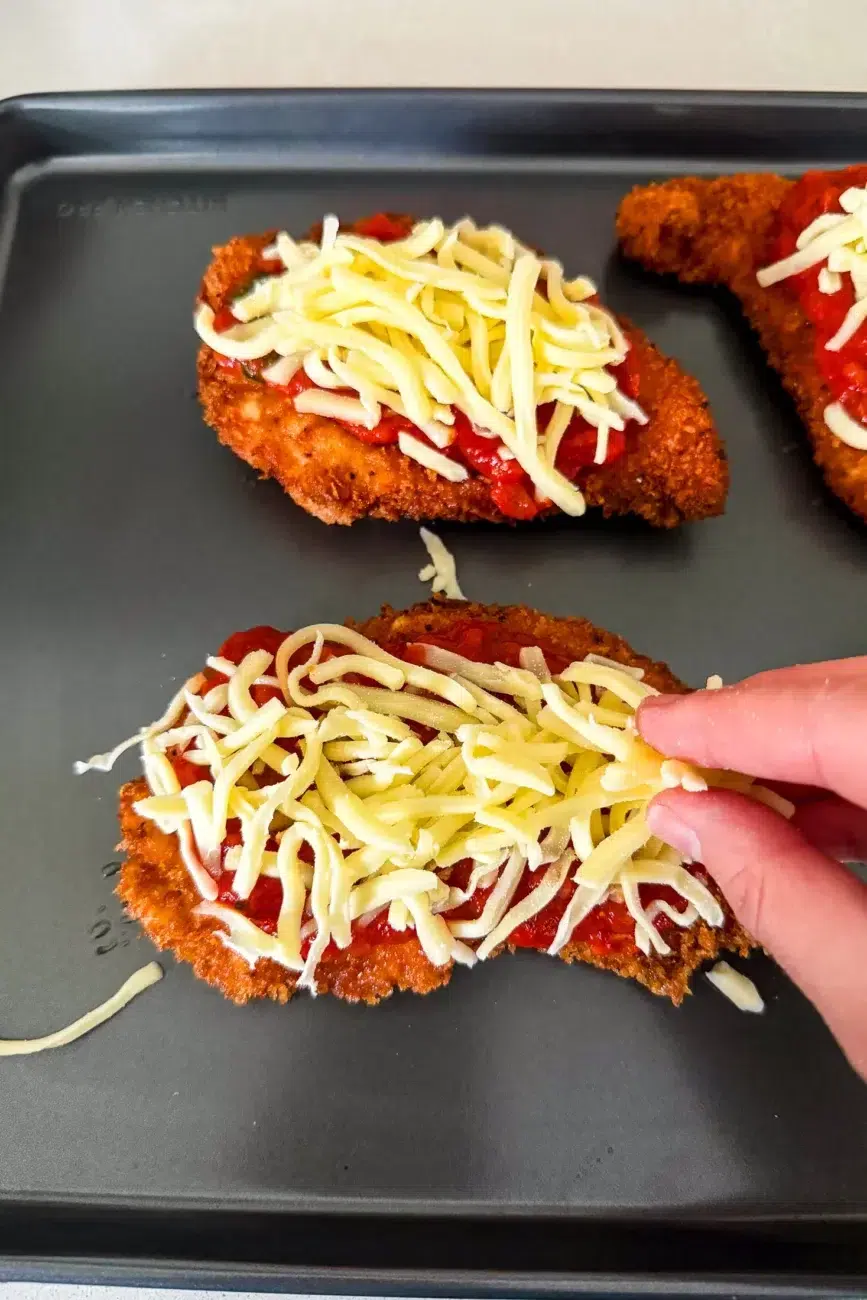 Chicken schnitzels topped with mozzarella cheese