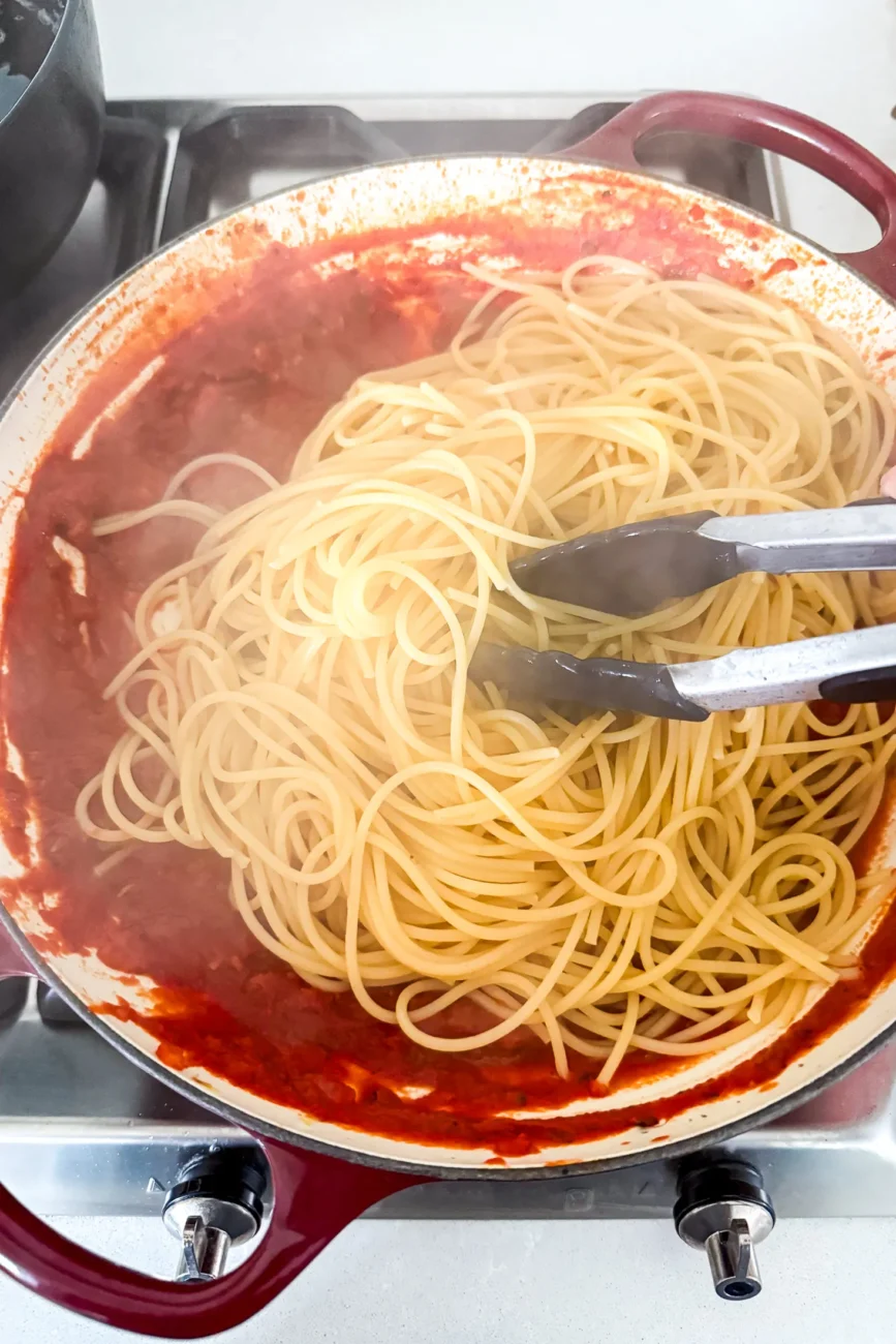 Cooked spaghetti added directly to pan with remaining tomato and basil sauce