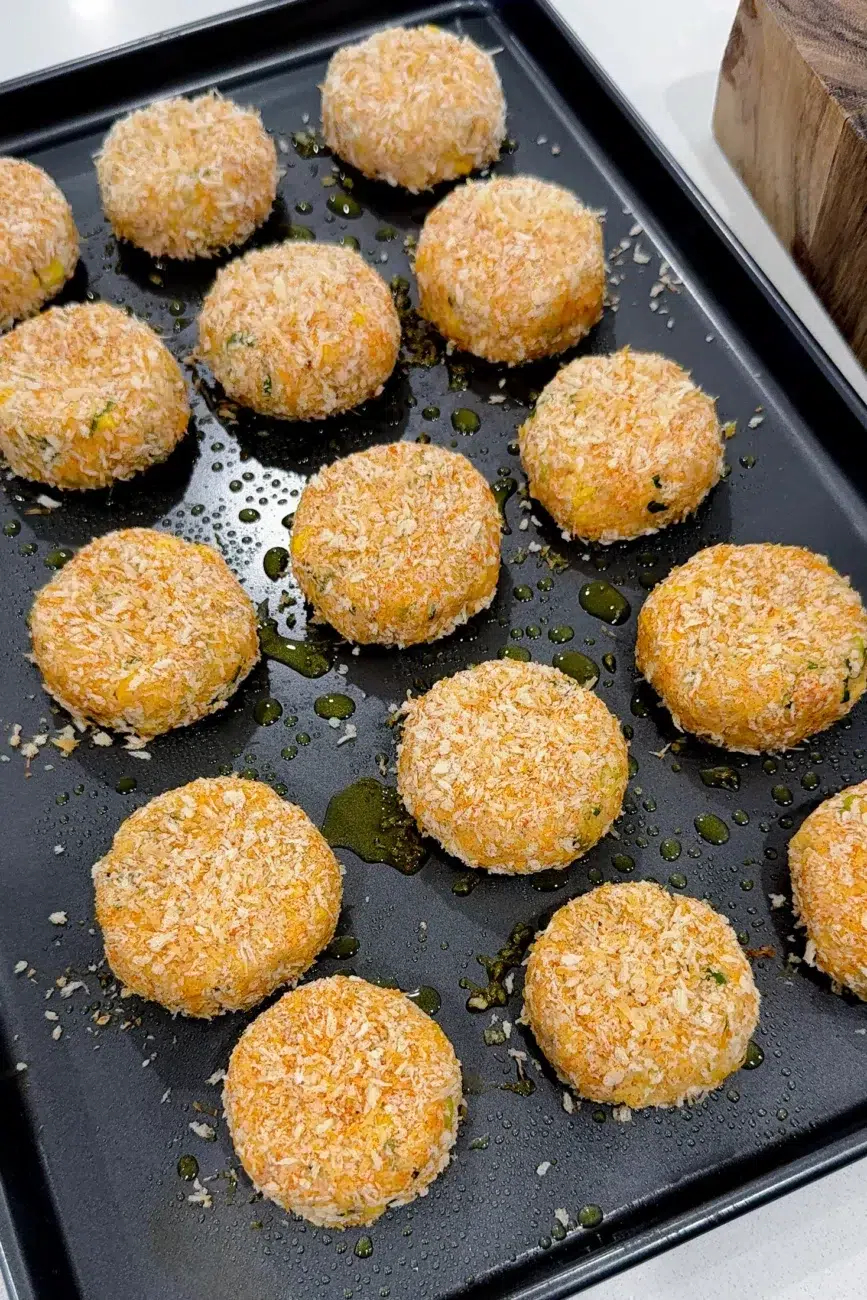 Fish cakes lined on tray ready for baking