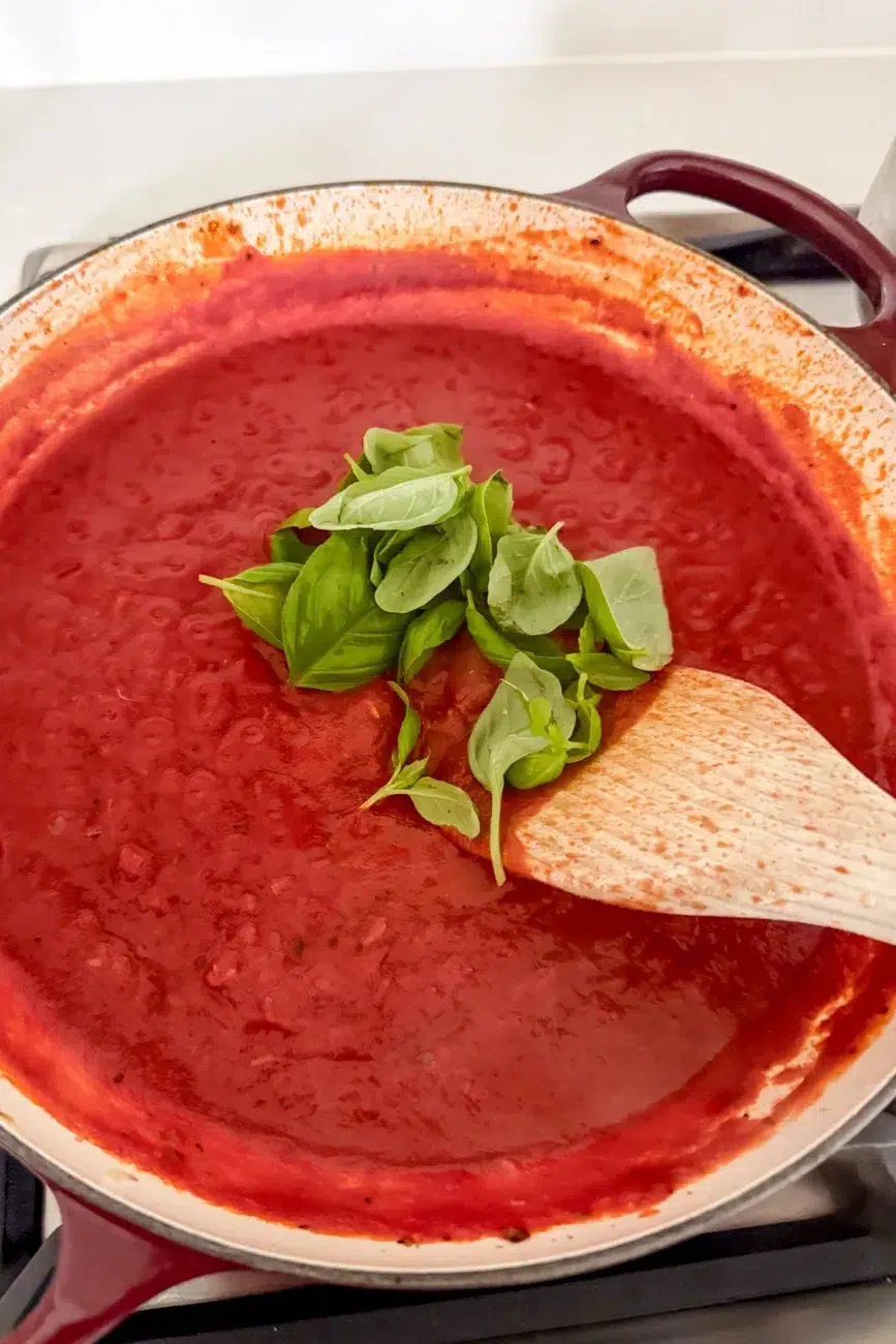 Fresh basil added to tomato sauce after heat is turned off